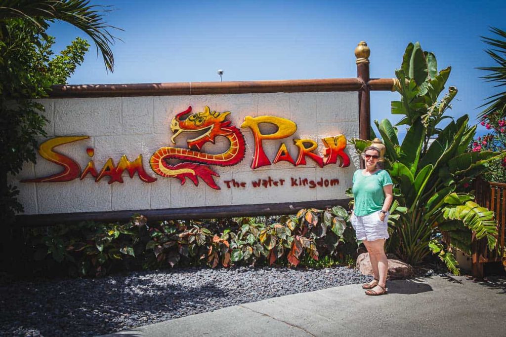 A woman standing next to Siam park entrance.